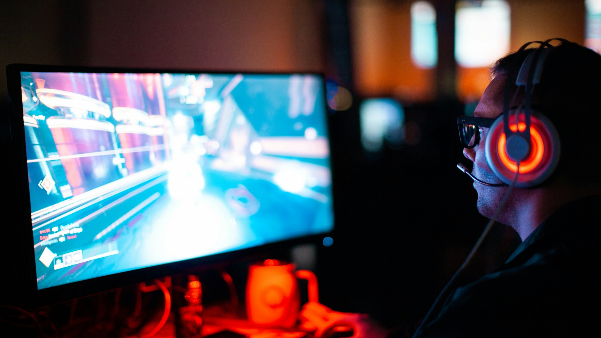 Players at illuminated battle stations inside the arena